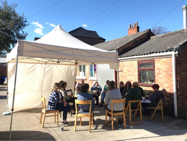 Group of four white women with long hair in a gallery setting, each one an organiser in Wirral. Diana, Julia, Alison and Lyndsay